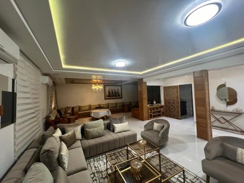 a living room with a couch and a table at Villa Lalla Laroussa in Kenitra