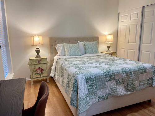 a bedroom with a large bed and two lamps at Varena Condo in Lake Charles