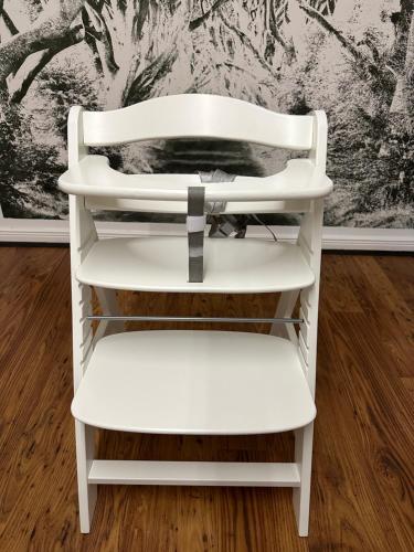 a white chair sitting in front of a wall at Remedium Appartements in Vlotho
