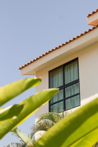 a window on the side of a house at San Trópico Boutique Hotel & Peaceful Escape in Puerto Vallarta