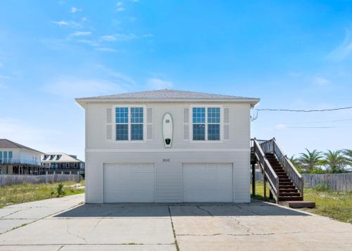 a white house with a garage at Maldonado Beach House in Pensacola Beach