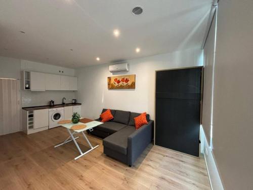 a living room with a couch and a table at A&R Isla de la Palma in San Sebastián de los Reyes