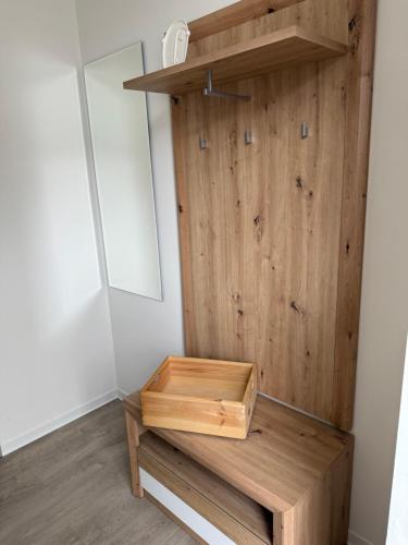 a room with a wooden wall with a wooden bench at Apartmány U Kostela in Uničov