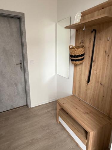 a room with a wooden bench next to a door at Apartmány U Kostela in Uničov