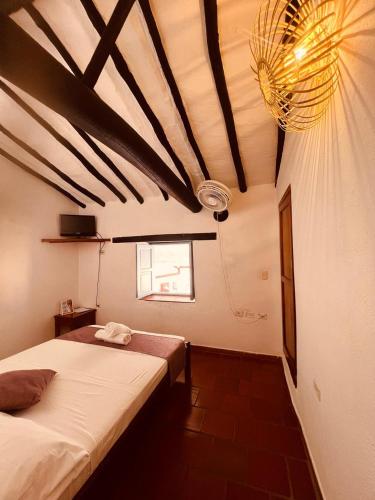 a bedroom with two beds and a ceiling at Aura Hotel Parque Barichara By Infinity in Barichara