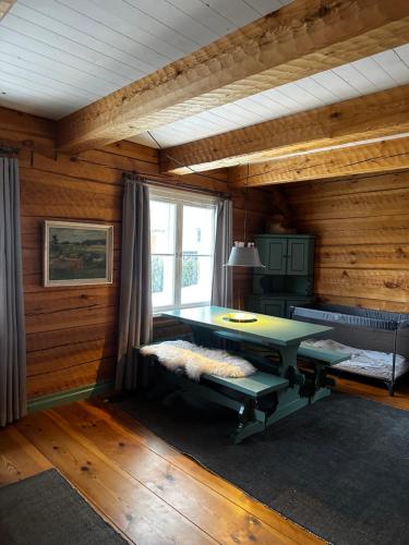 a living room with a table and a window at Cottage with sauna, in the heart of the Tammisaari in Tammisaari