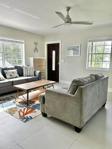 a living room with a couch and a table at Perfect remote work spot! Close to everything! in West Palm Beach