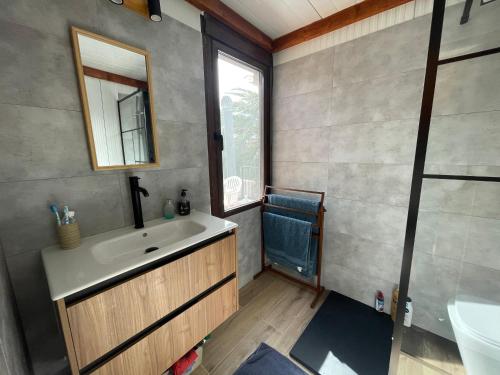 a bathroom with a sink and a mirror at CHALET en la PLAYA CON PISCINA in Marbella
