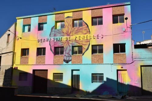 a building with a painting on the side of it at Casa taller Penelles in Penellas
