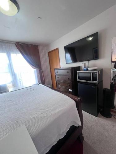 a hotel room with a bed and a television at Banquet Hotels Tacoma-Lakewood-Puyallup-DuPont-Lacey-Olympia in DuPont