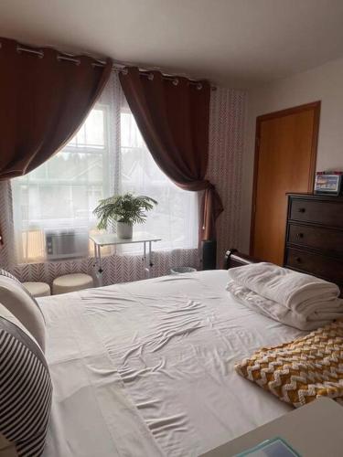 a bedroom with a large white bed with a window at Banquet Hotels Tacoma-Lakewood-Puyallup-DuPont-Lacey-Olympia in DuPont