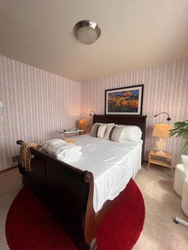 a bedroom with a large bed with a red rug at Banquet Hotels Tacoma-Lakewood-Puyallup-DuPont-Lacey-Olympia in DuPont