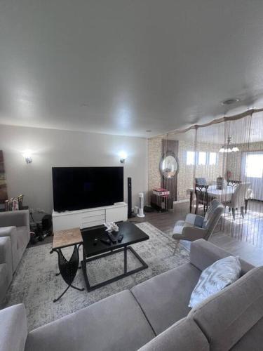 a living room with a couch and a tv at Banquet Hotels Tacoma-Lakewood-Puyallup-DuPont-Lacey-Olympia in DuPont