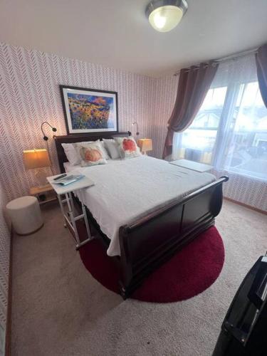 a bedroom with a large bed and a large window at Banquet Hotels Tacoma-Lakewood-Puyallup-DuPont-Lacey-Olympia in DuPont
