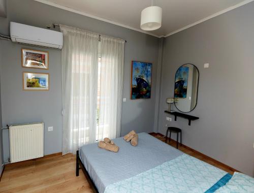 a bedroom with two beds and a mirror at Debbie's διαμέρισμα δίπλα στο νερό ! in Chalkida