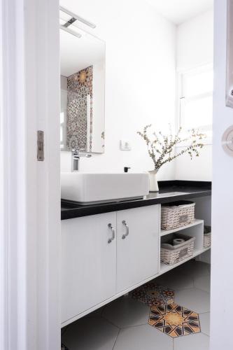 a white bathroom with a sink and a mirror at Casa Rai Déjate sorprender! in San Andrés