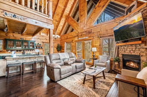 a living room with a couch and a fireplace at Near Dollywood with Pool Table-Hot Tub-Fire Pit-Game Room in Pigeon Forge
