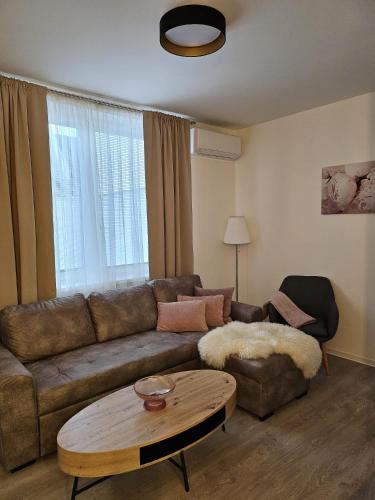 a living room with a couch and a coffee table at Apartmány U Kostela in Uničov