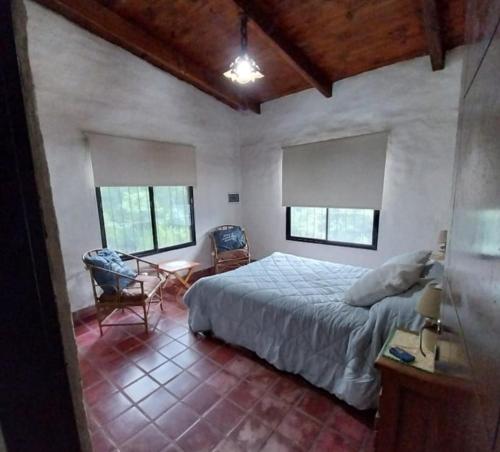 a bedroom with a bed and a table and chairs at Casa Naranja in San Javier
