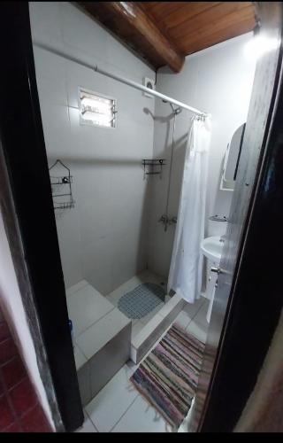 a small bathroom with a shower and a sink at Casa Naranja in San Javier
