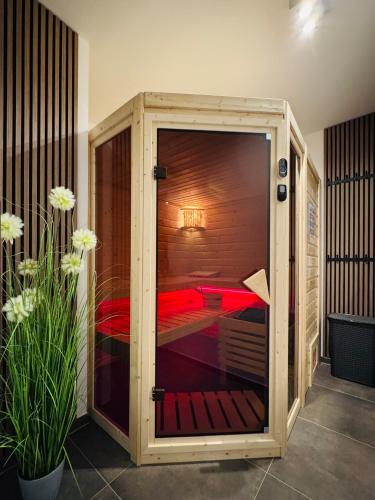 a room with a bed inside of a glass door at 8 Personen Ferienhaus ,,Seegelblick" am Goitzschesee, erste Reihe am Strand mit Sauna, Kamin, Wallbox & SUP in Pouch