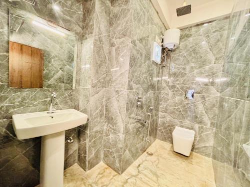 a bathroom with a sink and a shower at Hotel Nirvana Lakeside in Udaipur