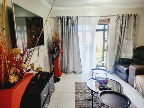 a living room with a couch and a table at Olympia in Pretoria