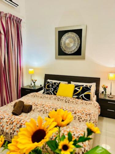a bedroom with a bed with yellow flowers on it at Seaside Spinola APT in St Julians, Queen beds in St Julian's
