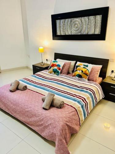 a bedroom with a large bed with stuffed animals on it at Seaside Spinola APT in St Julians, Queen beds in St Julian's
