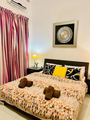 a bedroom with a bed with pillows on it at Seaside Spinola APT in St Julians, Queen beds in St Julian's