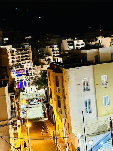 a view of a city at night with buildings at Seaside Spinola APT in St Julians, Queen beds in St Julian's