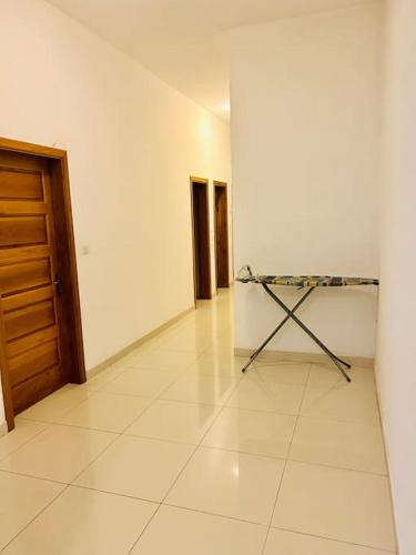 a room with a white floor and a wooden door at Seaside Spinola APT in St Julians, Queen beds in St Julian's