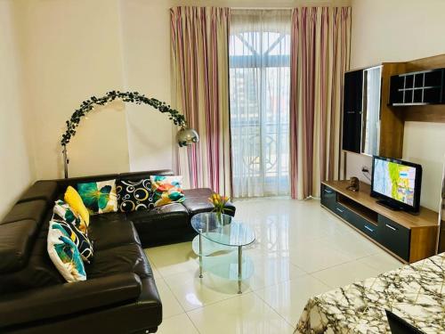 a living room with a leather couch and a glass table at Seaside Spinola APT in St Julians, Queen beds in St Julian's
