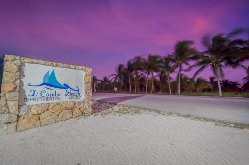 a sign for a resort on the beach with palm trees at San Bruno TROPICAL Villa With POOL in San Bruno