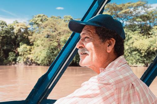 a man wearing a hat looking out the window of a river at Presidential Suites 15-Oceanview Condo in Playa Flamingo