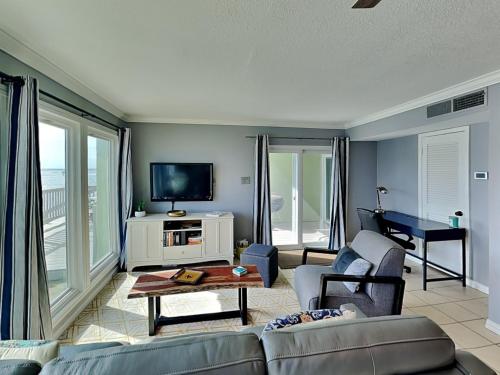 a living room with a couch and a table at Coastal Cozy and a View in Padre Island