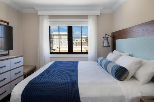 a bedroom with a large bed with a large window at The Atlantic Suites on the Ave in Delray Beach