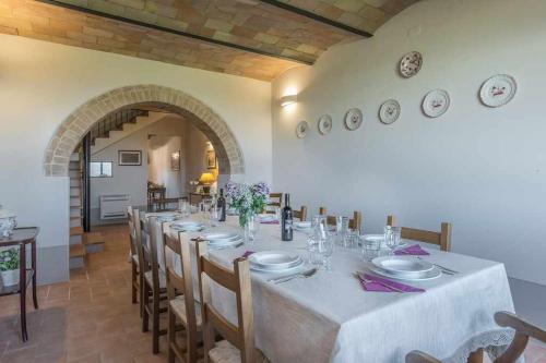 a large dining room with a long table and chairs at Villa I Cipressini piscina riscaldata spa Toscana in Pienza