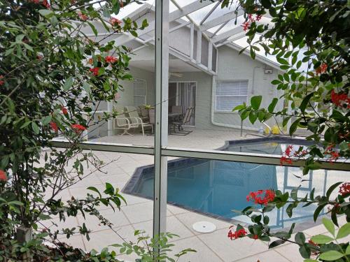 a house with a swimming pool seen through a window at Punta Gorda Home, Sleeps 10 in Punta Gorda