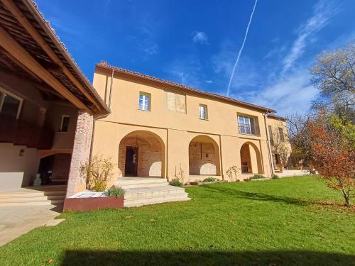 a large house with a green lawn in front of it at Santo Stefano Rondini in Vicoforte