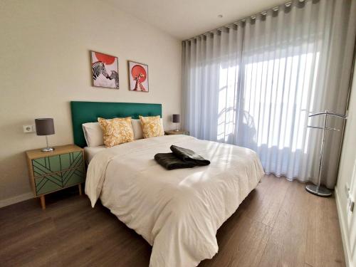 a bedroom with a large bed with a green headboard at SR Wellingtonia Estepona Centro in Estepona