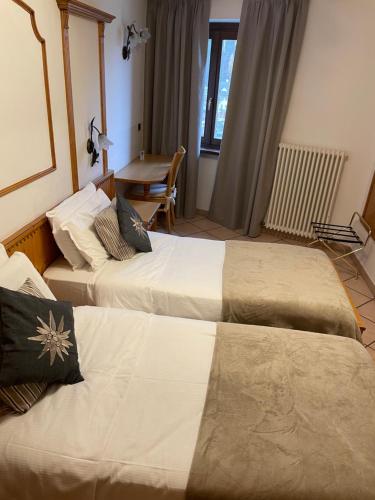 Postel nebo postele na pokoji v ubytování Hotel Valle Verde - Rent Ski & Bike