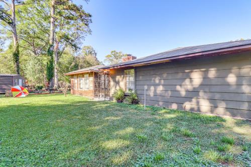 a house with a yard next to a building at 8 Mi to Jackson State University Peaceful Getaway in Jackson