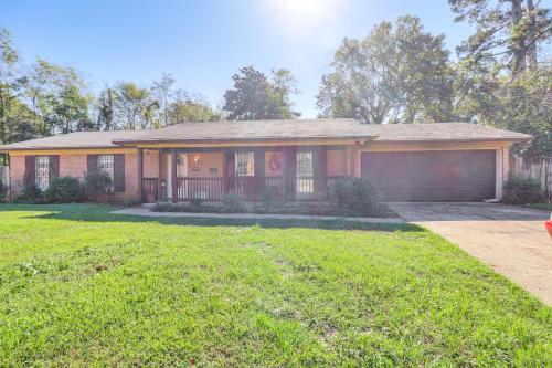 a house with a grass yard in front of it at 8 Mi to Jackson State University Peaceful Getaway in Jackson