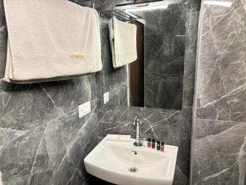 a bathroom with a sink and a mirror at Hotel Nirvana Lakeside in Udaipur