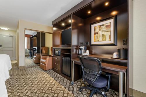 a hotel room with a desk and a bed at Best Western Plus InnTowner Madison in Madison