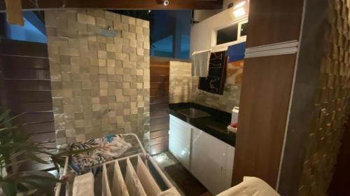 a small bathroom with a sink and a counter at Casa Condomínio Eusébio Amador in Eusébio