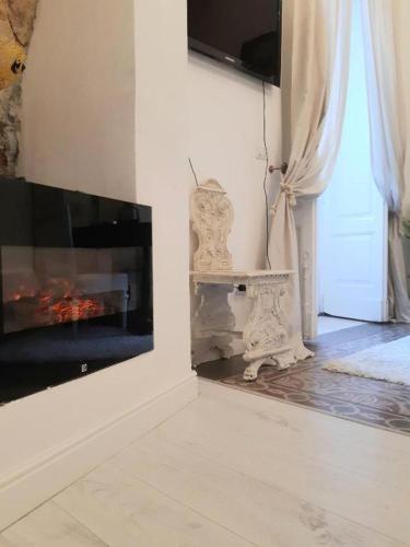 a living room with a fireplace next to a door at Morosoli Spa in Catania