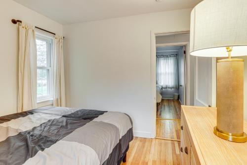 a bedroom with a bed and a lamp in it at Walk to Beach and Lake Michigan Manistee Bliss! in Manistee