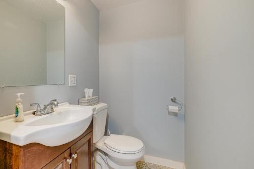 a bathroom with a white toilet and a sink at Walk to Beach and Lake Michigan Manistee Bliss! in Manistee